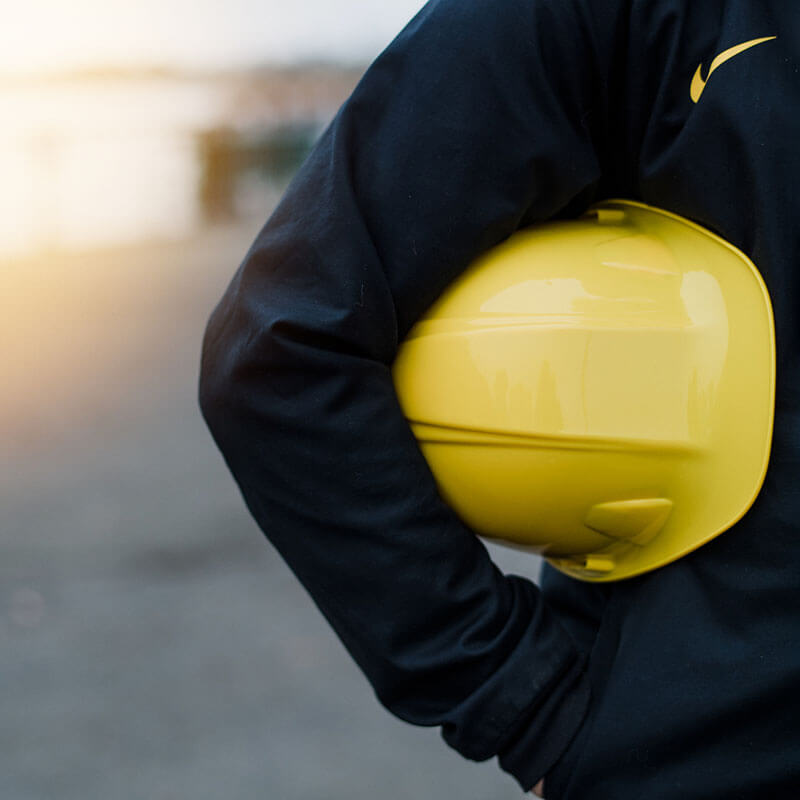 employee carrying hardhat